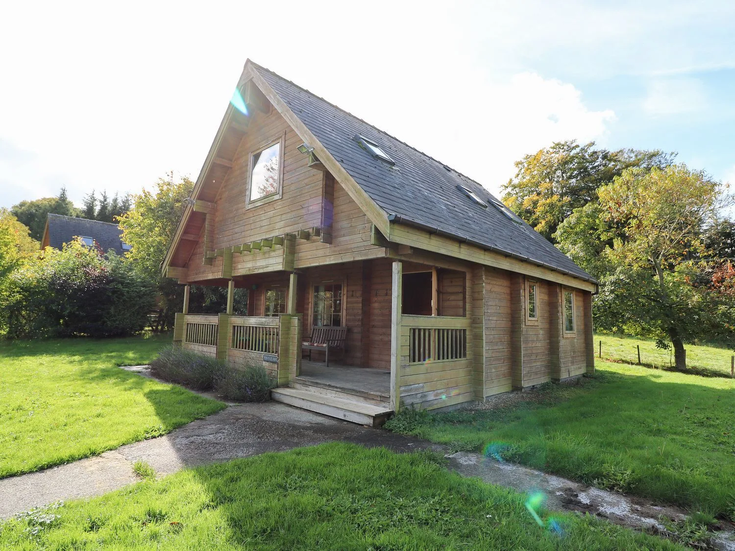 Pen Y Clawdd lodge with its porch and lawn